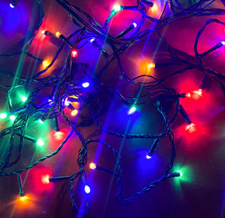 Fototapeta na wymiar Christmas electric garland lights on an orange background. Copy space.
