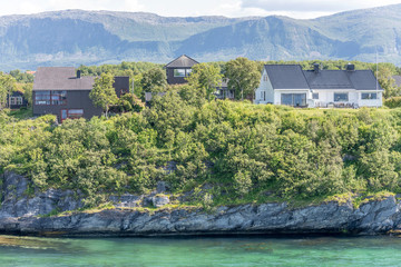 Fototapeta premium houses on green shore, Bronnoysund, Norway