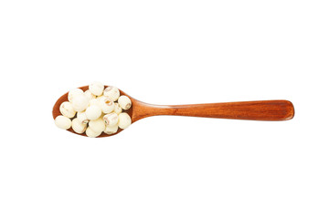 A wooden spoon scoop of lotus seeds is placed on a white background.