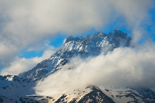 Tall rocky peak in clouds