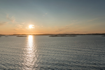 Fototapeta na wymiar fake sunset at scattered cliffs archipelago, near Naeroya island, Norway