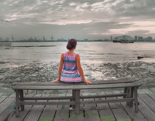 Tourist sitting at Yeoh jetty, Georgetown, Penang, Malaysia