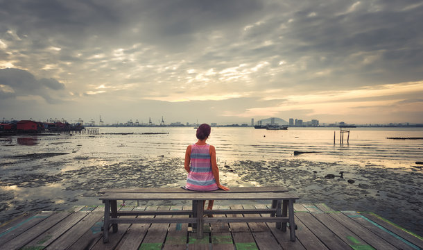 Tourist sitting at Yeoh jetty, Penang, Malaysia. Panorama