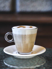 Coffee cup on glass table.