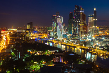 Moscow City. Russia. Area with skyscrapers. Tours of Moscow at night. Skyscrapers on the river bank. Night illumination of the city. Tall buildings. Vacation in Russia. Architecture. Sights.
