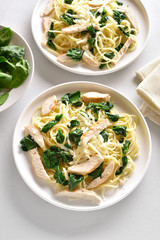 Spaghetti with spinach leaves, grilled chicken breast and cheese