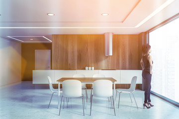 African woman in wooden kitchen with table