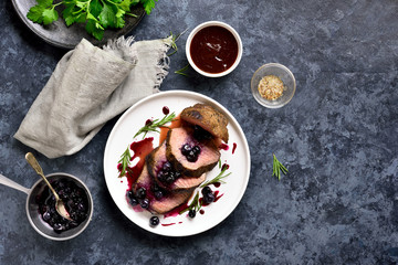 Sliced grilled beef with blueberry sauce