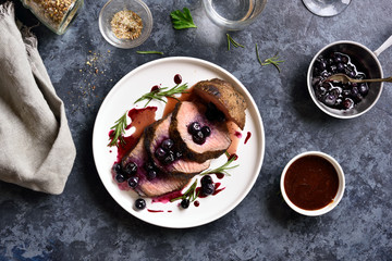 Sliced grilled beef with blueberry sauce