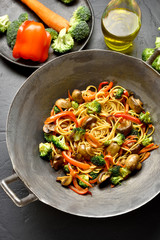 Udon stir-fry noodles with vegetables in wok