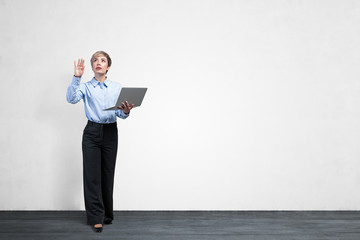 Woman with laptop using virtual screen, mock up