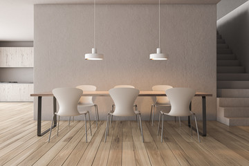 Beige dining room and kitchen with stairs