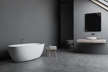 Obraz na płótnie Canvas Attic gray bathroom corner with sink and tub