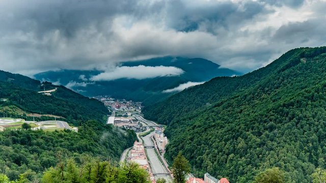 Time lapse video. Aerial view - evening at the Rosa Khutor ski resort. Fog dissipating after rain, beautiful mountain evening landscape