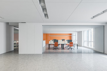 Bright white, orange open space with meeting room