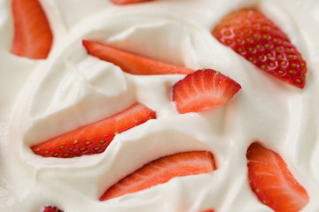 Closeup of fresh chopped strawberries in white yogurt