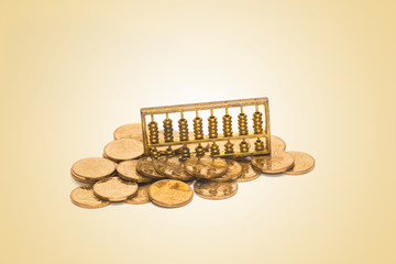 A gold abacus was placed on the background of the pile of COINS