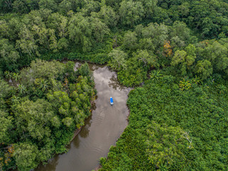 Fototapeta na wymiar Aerial view of boat in the mangrove Rio Sierpe river in Costa Rica deep inside the jungle