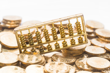 A gold abacus was placed on the background of the pile of COINS - obrazy, fototapety, plakaty