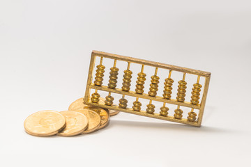 A gold abacus was placed on the background of the pile of COINS