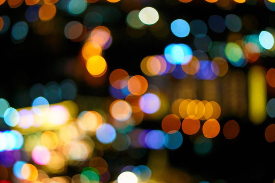 Beautiful bokeh circles. Out of focus photo of the night city.