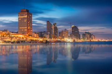 Fototapeta na wymiar Tel Aviv Skyline, Israel. Cityscape image of Tel Aviv beach with some of its famous hotels during sunrise and night