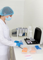Female doctor making diagnosis of samples on high quality lab equipment