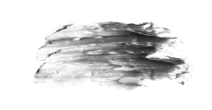 Brush strokes and texture of black detox facial mask or acrylic paint isolated on white background
