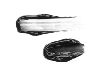 Brush strokes and texture of black detox facial mask or acrylic paint isolated on white background