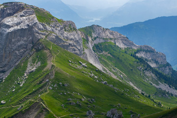Fototapeta na wymiar Pilatus Mountain hiking track with green grasslands and the Mountain 