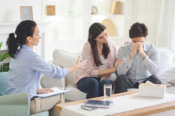 Loving wife supporting her husband during psychotherapy session