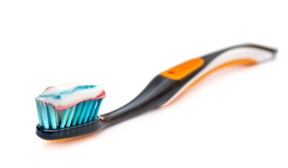 Toothbrush with toothpaste on white.