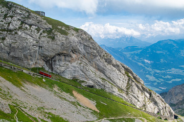 Pilatus Mountain hiking track with green grasslands and the Mountain  