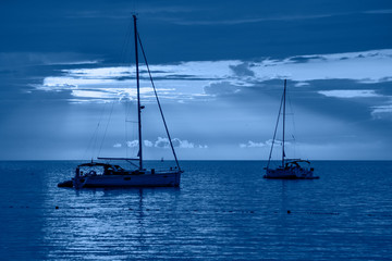 Beautiful night sea, yachts and full moon. Night classic blue seascape.