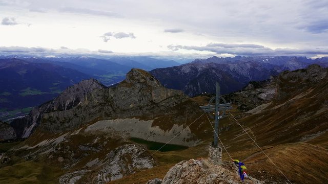 View of the alps and the summit cross of Rofanspitze mountain in the Austrian Alps on an overcast day