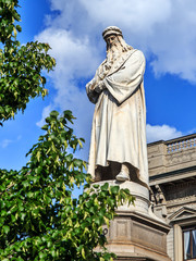 The statue of Leonardo da Vinci in Piazza della Scala in front of Palazzo Marino. Milan, Italy.