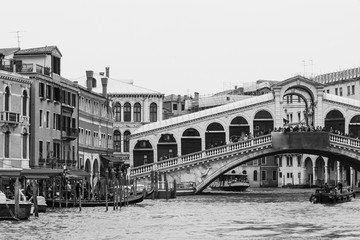 Black and white photo of the Rialto bridge taken from the Grand Canal in Venice, Italy - 308197382