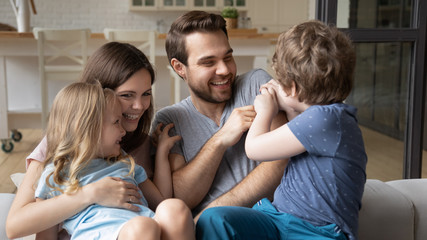 Children spend time with parents playing tickling dad feels overjoyed
