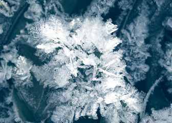 winter background with snowflakes crystals patterns and snow on frozen grass