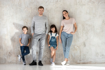 Full length family portrait of parents and children.
