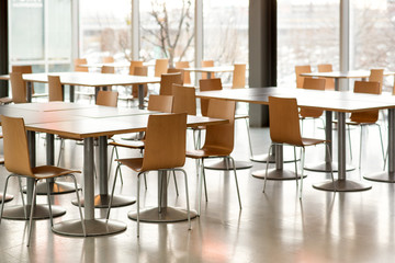 Interior of empty canteen with tables and chairs - Powered by Adobe