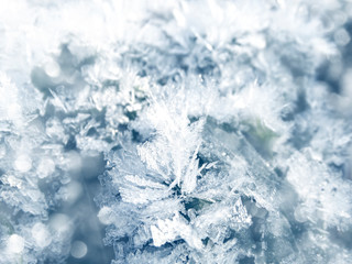 winter background with snowflakes crystals patterns and snow on frozen grass