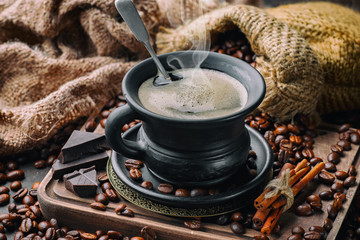 Coffee in a cup and saucer on an old background.