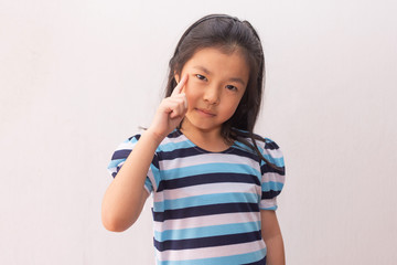 Young and cute Asian little girl thinking