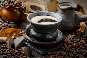 Coffee in a cup and saucer on an old background.