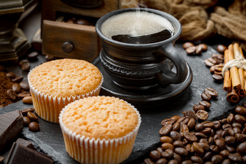 Coffee in a cup and saucer on an old background.