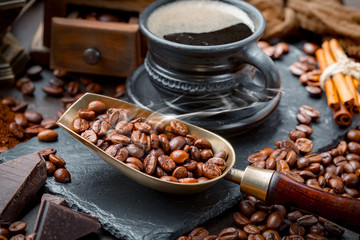 Coffee beans are roasted in a pan with smoke.