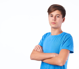 Portrait of caucasian teen boy wearing blue t-shirt on white background. Studio shot of people emotions.