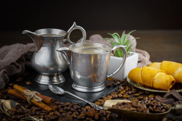 Coffee in a cup and saucer on an old background.