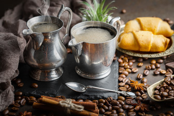 Coffee in a cup and saucer on an old background.